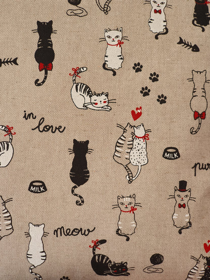Close of up of the 'in love' cat pattern fabric.  The black and white cats, paws and hearts pattern is on a neutral background linen look fabric.