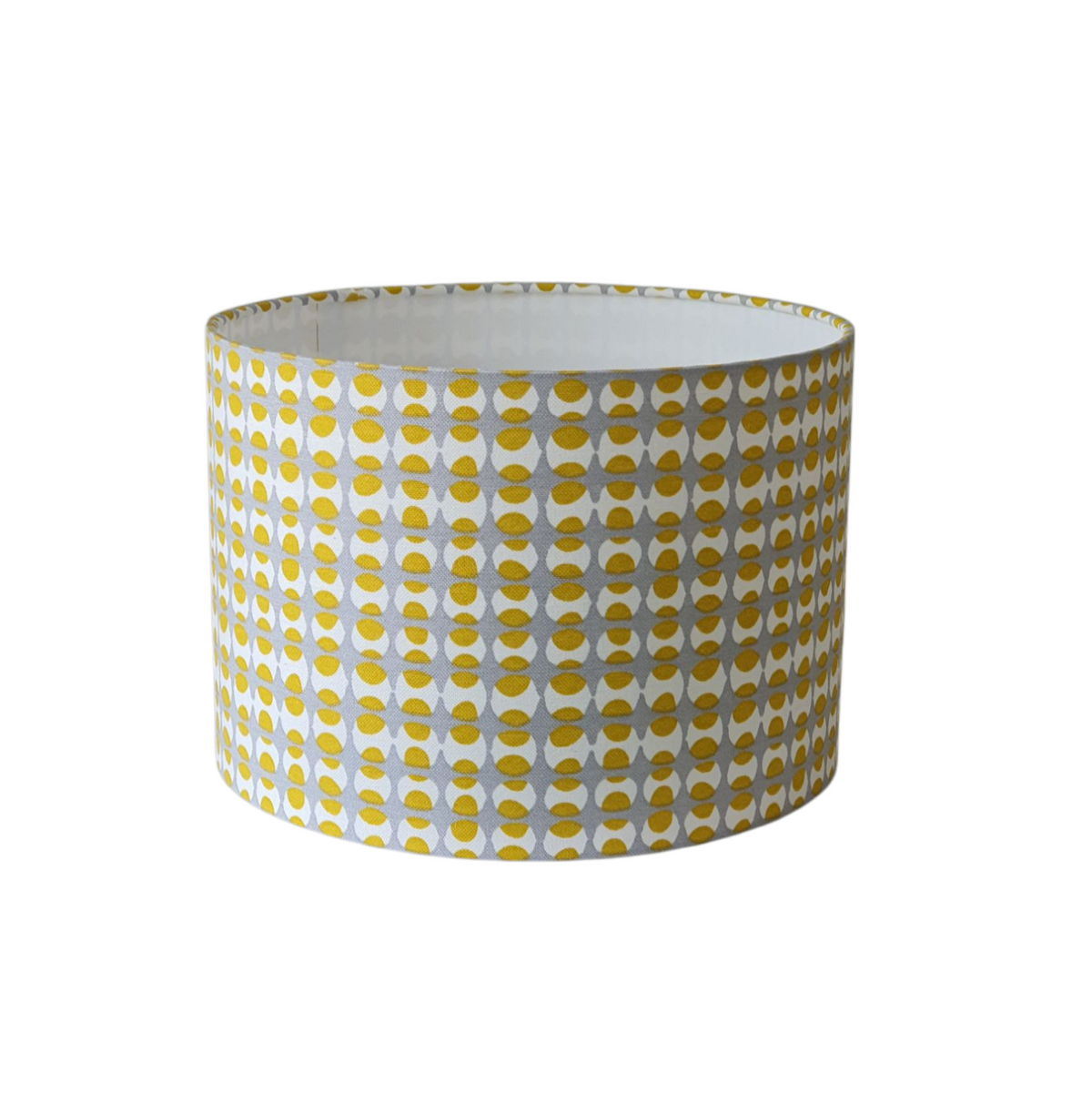 Handmade 30cm drum shade made with geometric yellow and grey patterned fabric.  Due to the pattern being non directional the handmade shade would be suitable for a lamp base or a ceiling fitting.