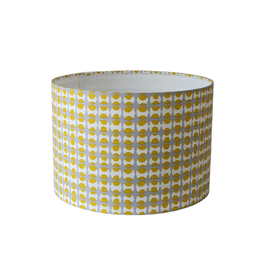 Yellow and Grey Geometric drum lampshade with yellow and grey geometric shapes.