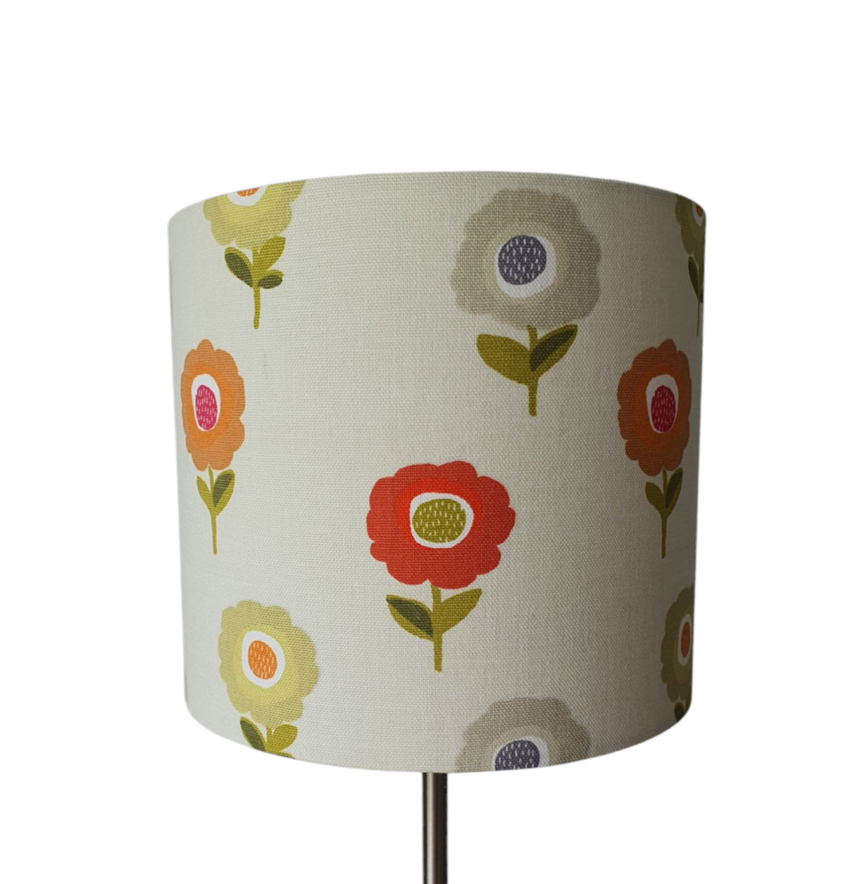 This photo shows the different coloured retro style flowers on the fabric used in the making of this lovely handmade 20cm drum lampshade.