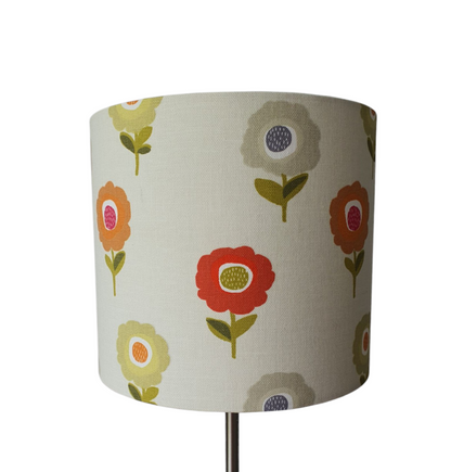 This photo shows the different coloured retro style flowers on the fabric used in the making of this lovely handmade 20cm drum lampshade.
