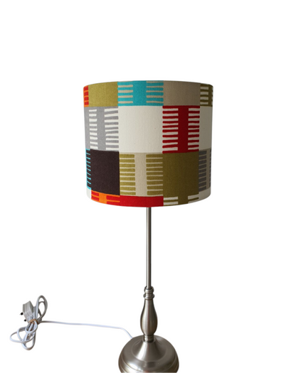A photo of the handmade drum lampshade on a base (which is not included and is for illustration purposes only). The shade would also be suitable for a ceiling fitting as the pattern is non directional.