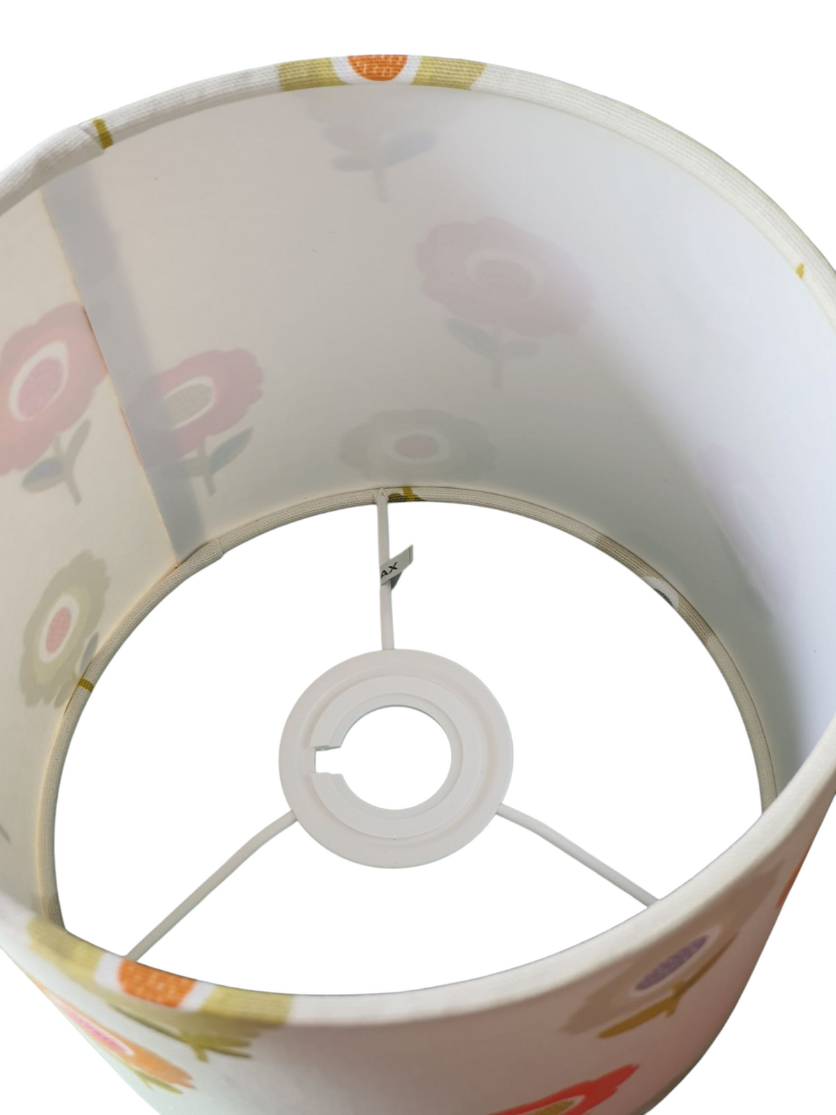 A view looking from the top of the handmade drum lampshade down to the rings which shows the inside of the lampshade and the fire retardant white PVC.