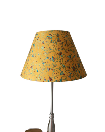 The handmade shade shown on a lamp base, which is not included.  The pattern of the fabric is called Palatial Gardens and is in honey gold.