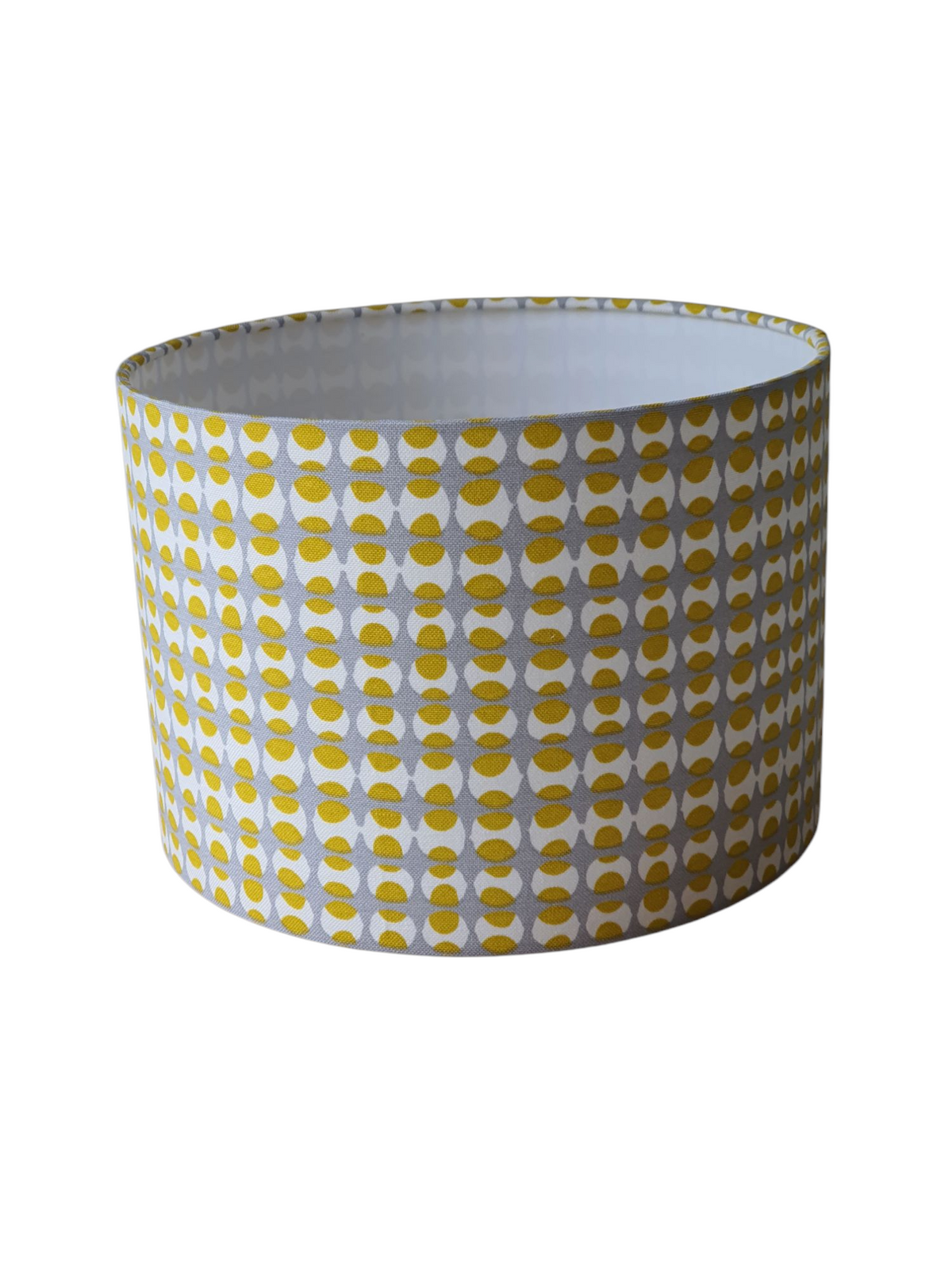 Another photo where the rings are at the bottom of the shade and again confirming how the shade can be used for a lamp base due to the non directional geometric pattern in yellow and grey.