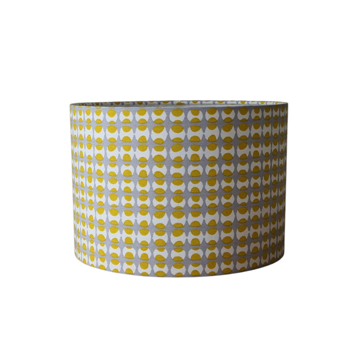 Handmade 30cm drum shade made with yellow and grey geometric patterned fabric.  The drum shade could be used on a lamp base or a ceiling fitting due to the pattern being non directional.