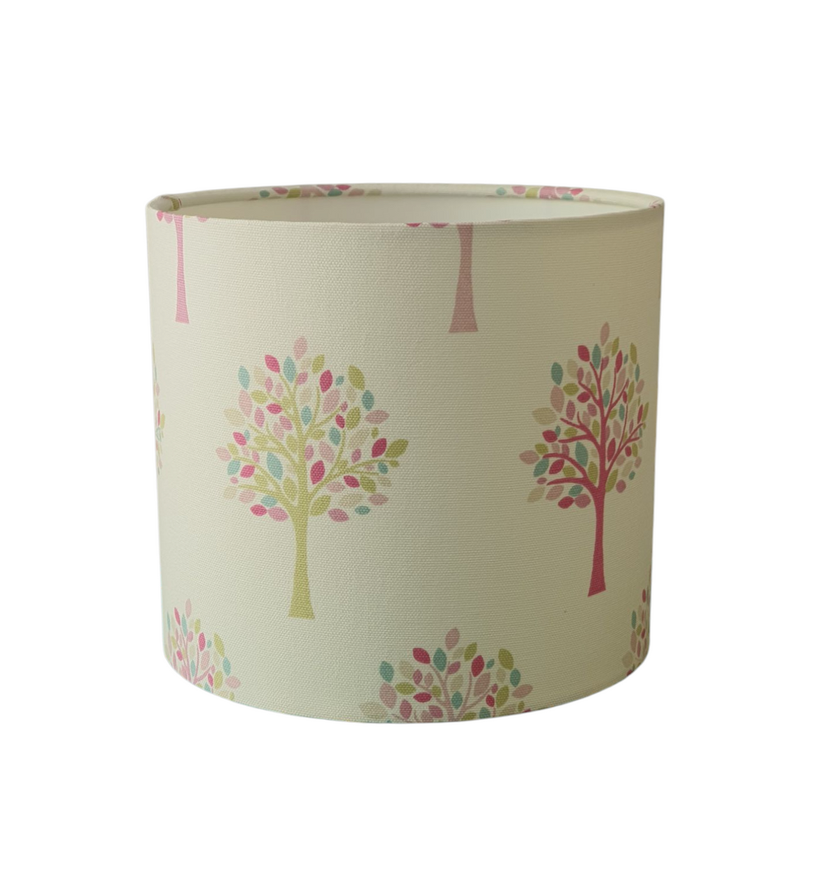 Two of the different coloured trees with their pastel leaves are shown on the lampshade fabric in this photo.  The drum lampshade is 20cms diameter and 18cms in height.
