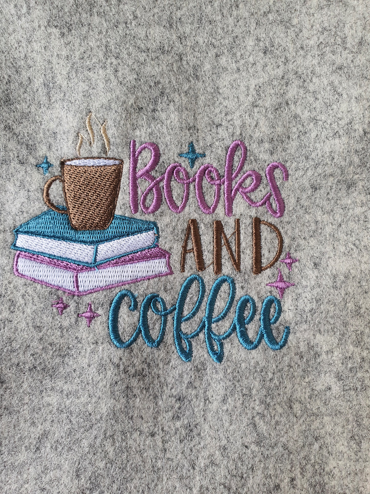A close up of the machine embroidered pattern on the front of the handmade padded Book Cover.