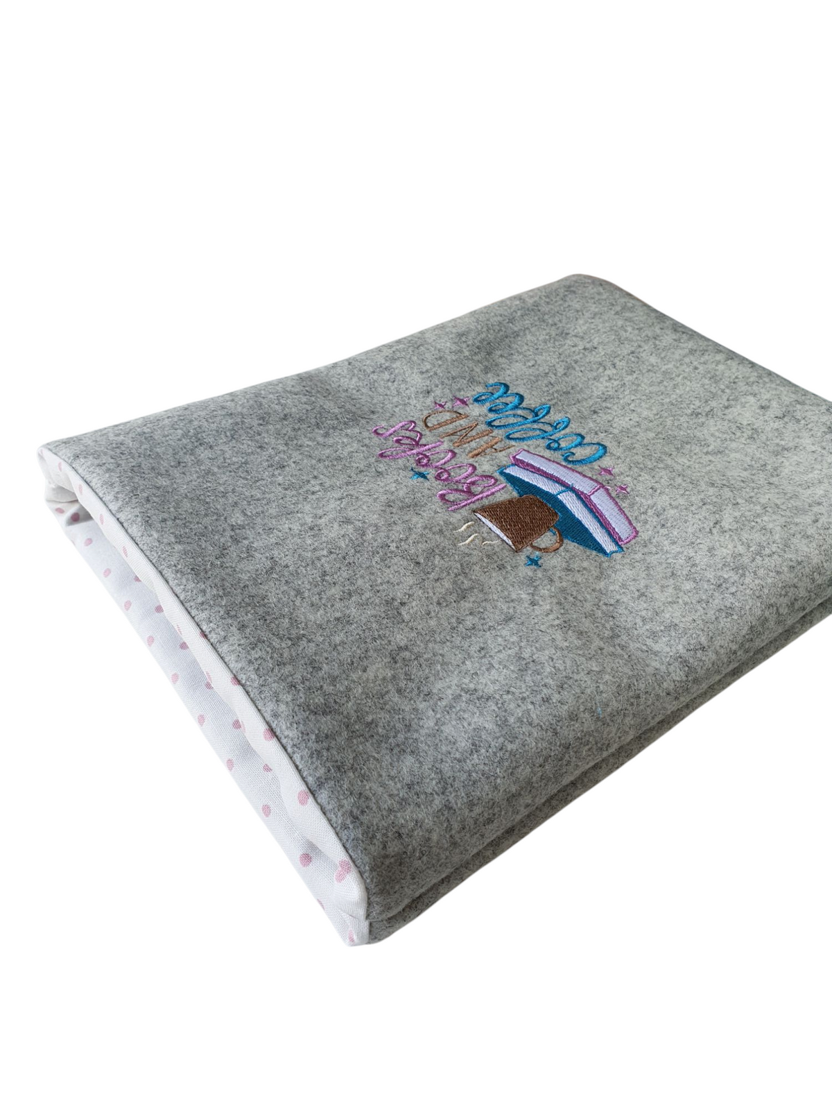 This photo shows the Book Pouch sideways and the polka dot lining, along with the light grey boiled wool and pattern can be seen.