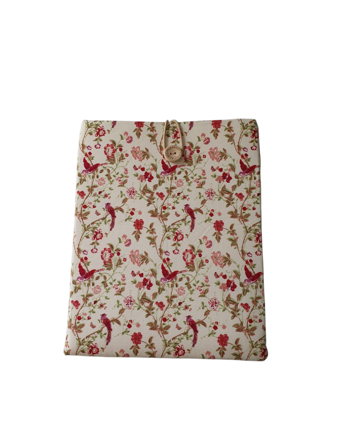 A front photo of the handmade padded Book Sleeve.  The floral and cranberry coloured hummingbird pattern is on a light coloured background.  The Book Cover fastens with an elastic loop and button.