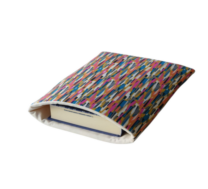 Handmade foam padded multicolour stripe Book Pouch and lined with neutral coloured cotton fabric.  The book in the photo is not included and is for illustrative purposes only.