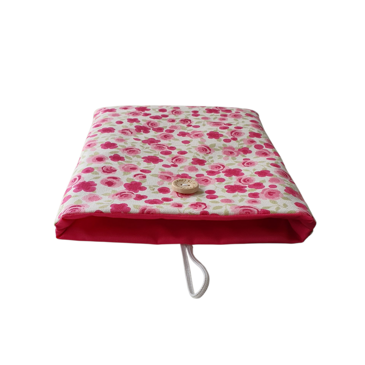 This photo shows the complementing pink fabric which has been used to line the Book/Kindle Pouch, as well as the floral pattern, elastic and button closure.