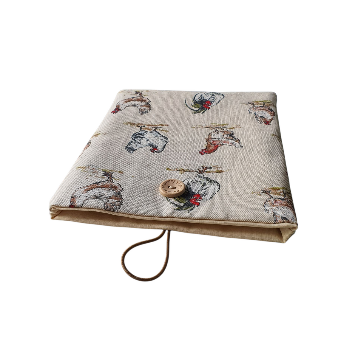 The padded Book Pouch showing the neutral fabric lining the Book Sleeve, together with the button and elastic fastening.