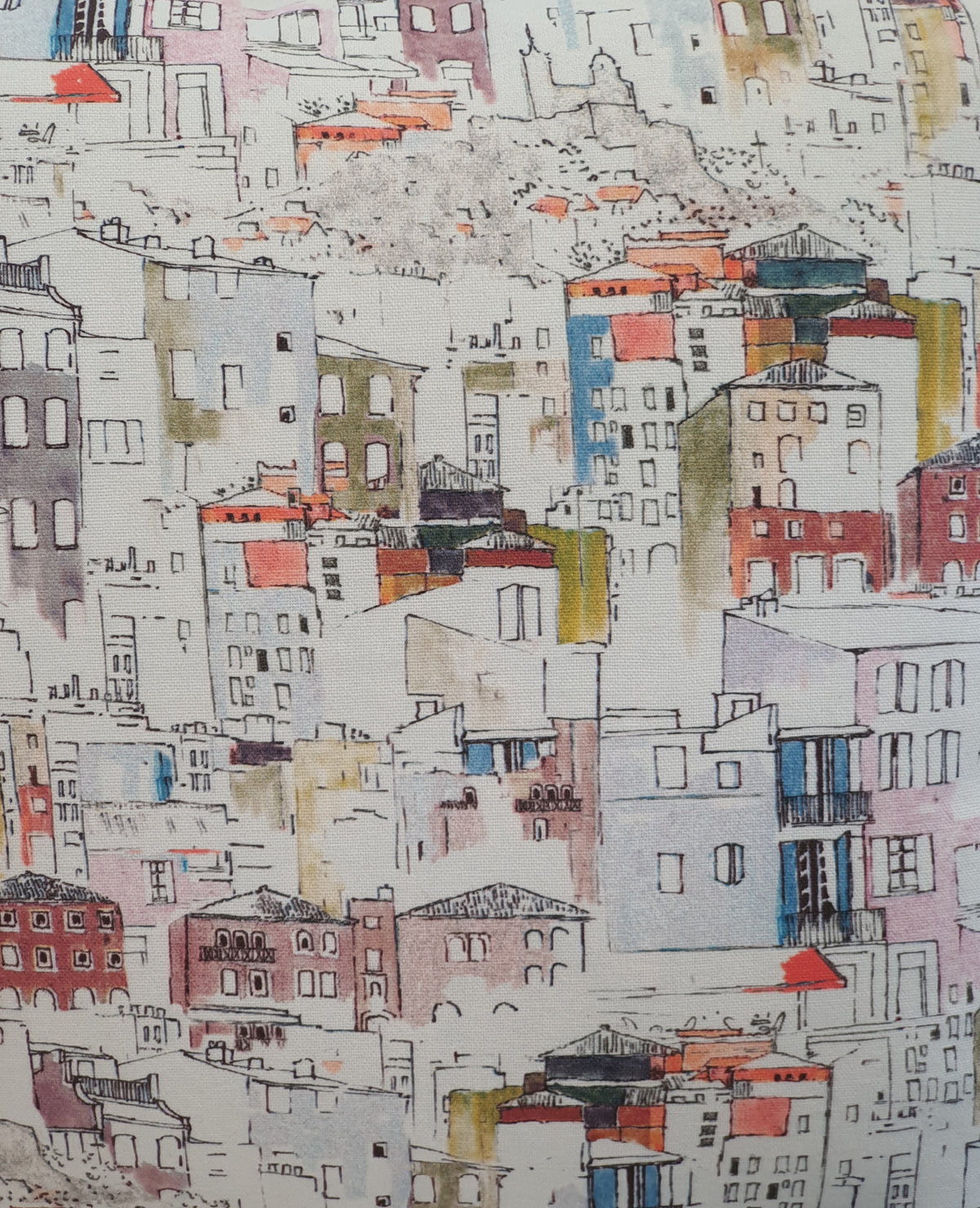 Colourful watercolour style Italian style houses on a light background fabric.  This photo is a close up of the multicolour watercolour style houses, which it is  said is based on houses in Florence.