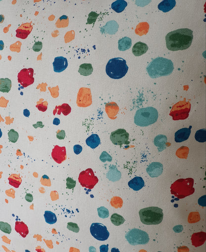 Close up of the multicolour Splat Paintbox fabric pattern.  The colours include red, shades of blue, green and peachy orange colours.