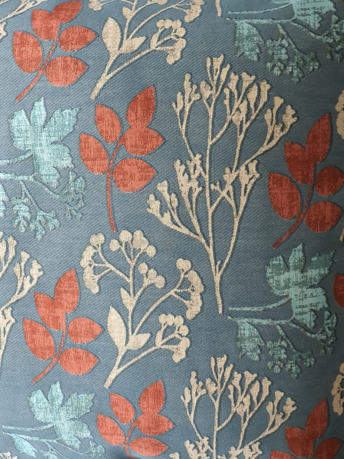 Close up of the Elliott Teal Peacock fabric by Prestigious Textiles which has been used to make the front of the cushion cover.