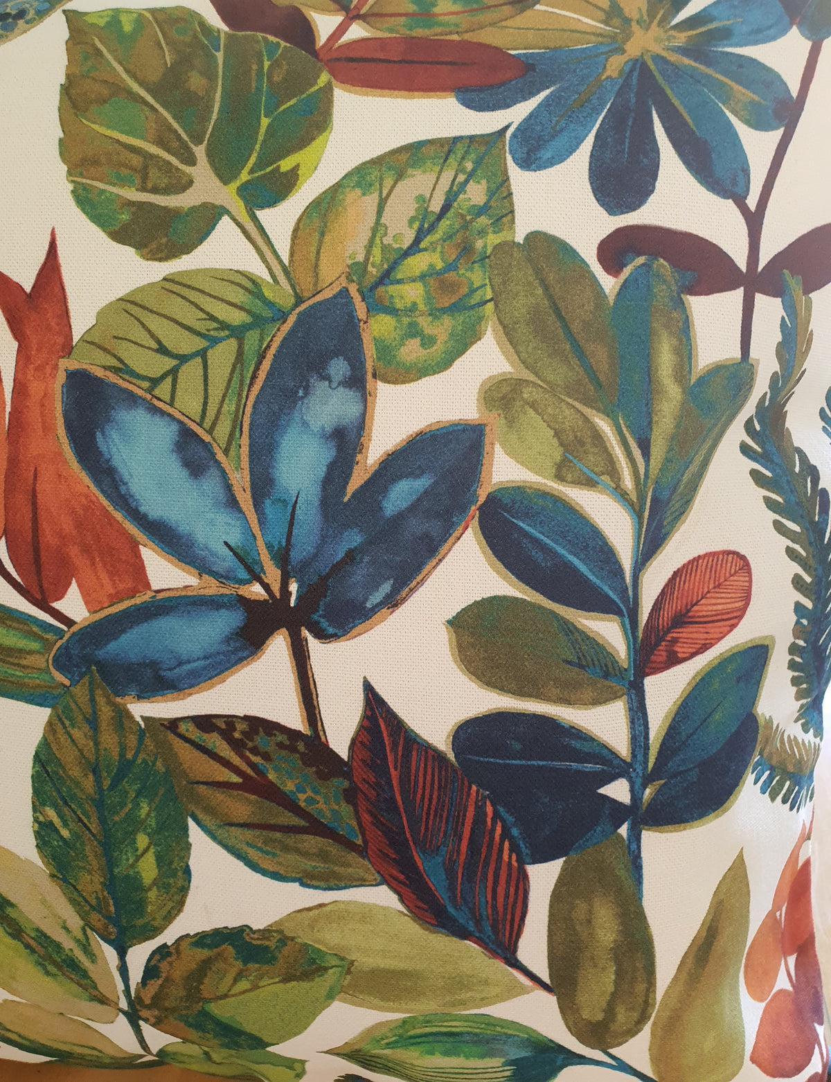 Close up of part of the colourful leaf pattern which is on a light background.