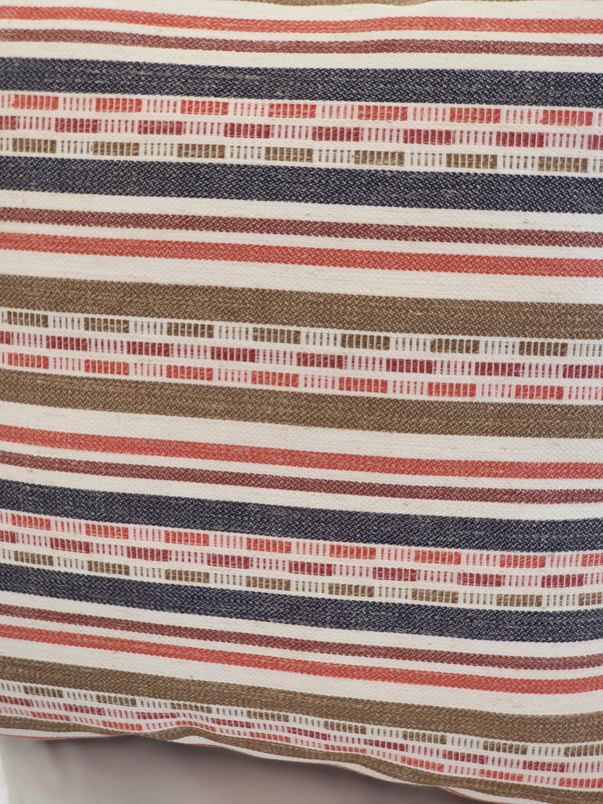 A close up of the multicolour striped fabric used to make the zipped cushion cover.