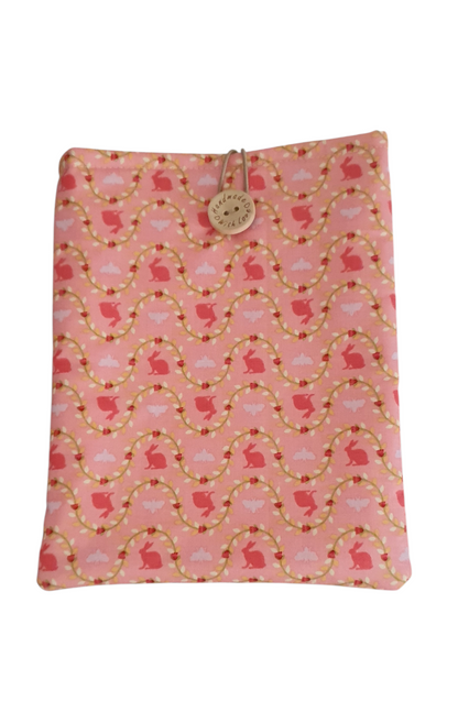 Handmade padded Book/Kindle Pouch, being an ideal Book Lovers Gift.  The handmade Book Cover has been made with pretty bunny patterned fabric, is padded with fusible wadding and has elastic and button fastening.