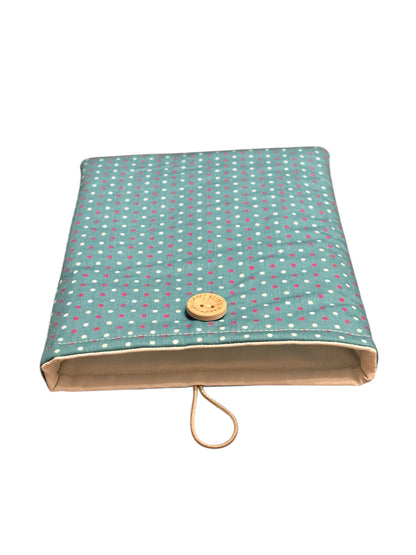 The handmade padded Book Cover is lined with neutral fabric, padded with fusible fleece and has elastic and button fastening.