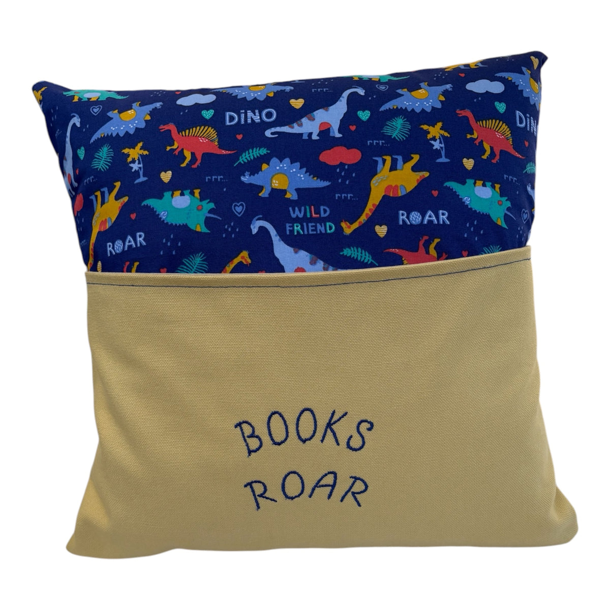 Handmade Book Cushion in multicolour Dinosaur patterned fabric with a front pocket which will hold a book.   The insert is removed via the pocket on the front of the cushion.  The wording 'Books Roar' has been machine embroidered.