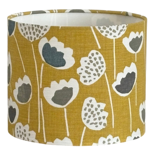 Skandi Saffron Floral drum lampshade with grey and white flowers on saffron yellow fabric.