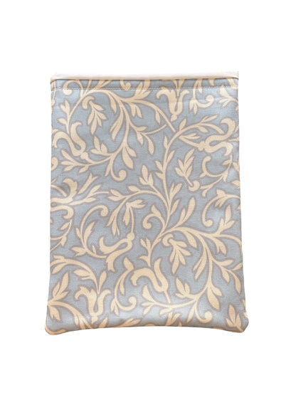 The cream vine leaf style pattern is on a pale blue background, lined with neutral fabric and padded with fusible fleece.  This is an ideal book accessory gift for you or for someone you know who loves reading.