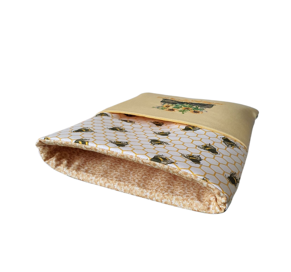 The padded Book Pouch is lined with complementing small daisy patterned fabric.